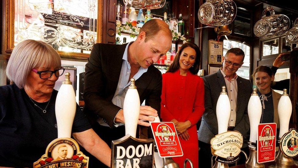 Prince William pours a beer during a visit to the Dog and Duck pub in Soho