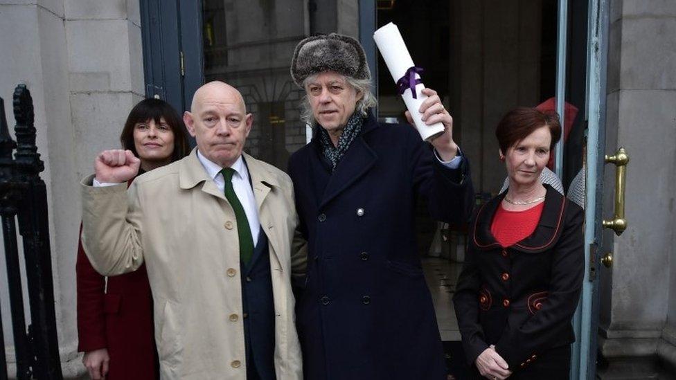 Bob Geldof (centre) hands back his Freedom of Dublin award