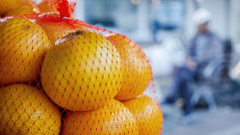 Oranges in plastic wrapping