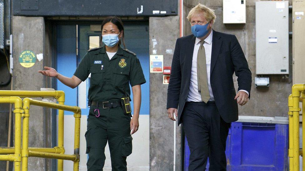 Boris Johnson wears a mask during a visit to London Ambulance Service