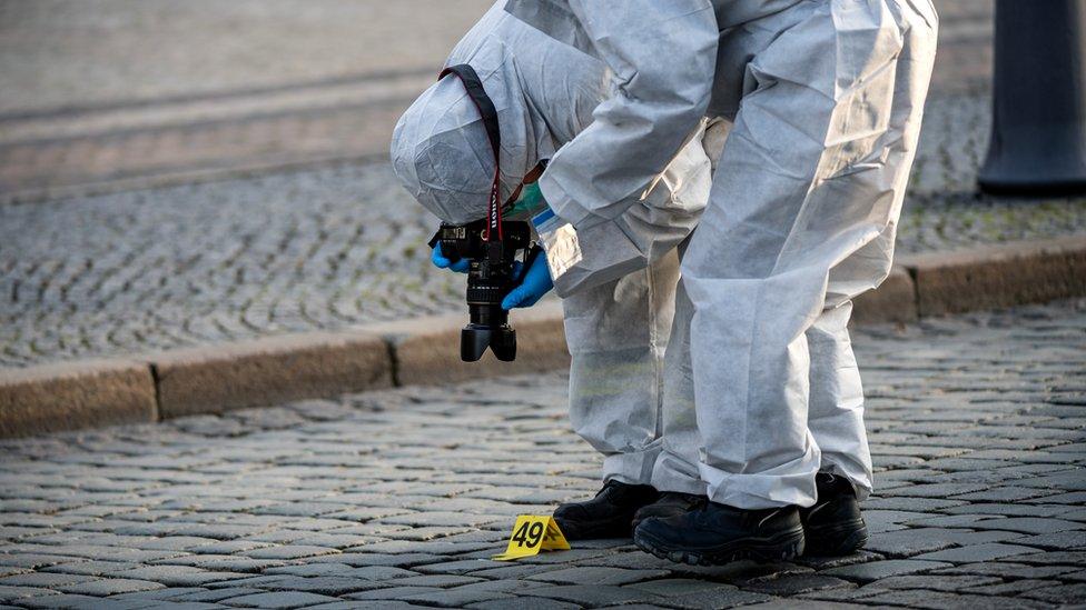 Criminal police investigate the outside the Residenzschloss palace that houses the Gruenes Gewoelbe (Green Vault) collection of treasures in Dresden, Germany, 25 November 2019