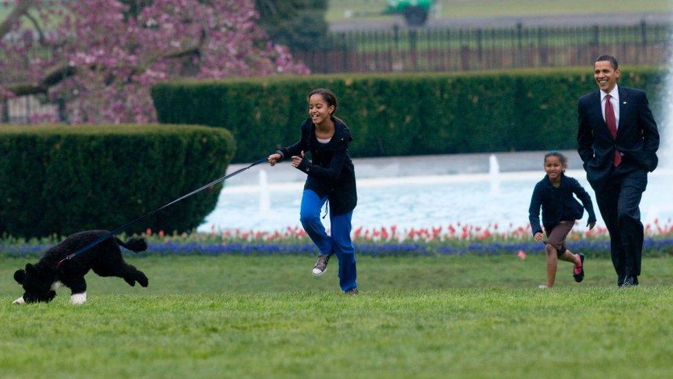 Sasha and Malia Obama with their dog