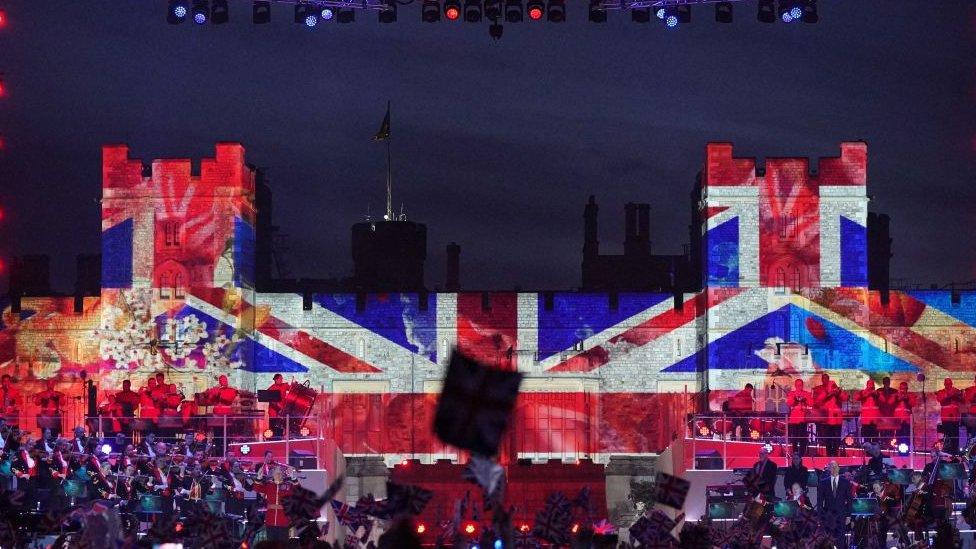 Crowds watch performers inside Windsor Castle grounds during the Coronation Concert, in Windsor, west of London