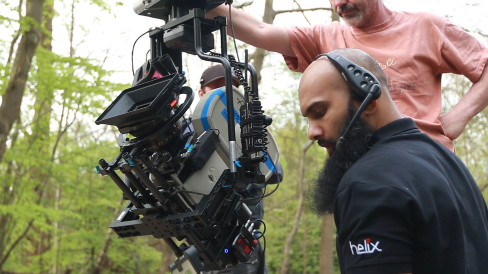 Rizwan Wadan operating a camera