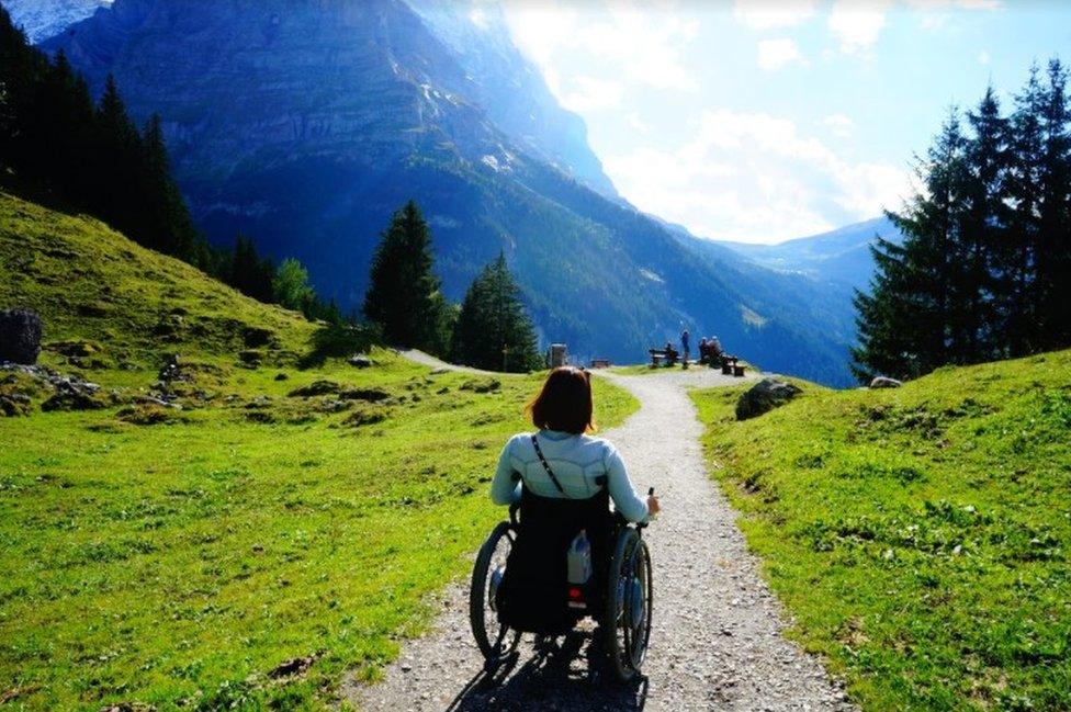 Seyoon Jane Hong on a moutain trail in her wheelchair
