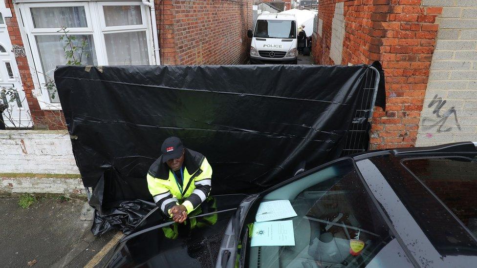 Black tarpaulin in alleyway