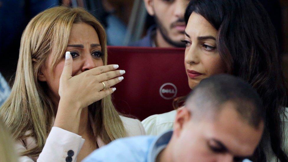 Marwa Omara (left) is comforted by Amal Clooney after Mohamed Fahmy and Baher Mohamed are convicted by a court in Cairo (29 August 2015)