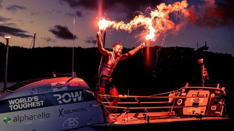 Elliot Awin celebrates after finishing the challenge