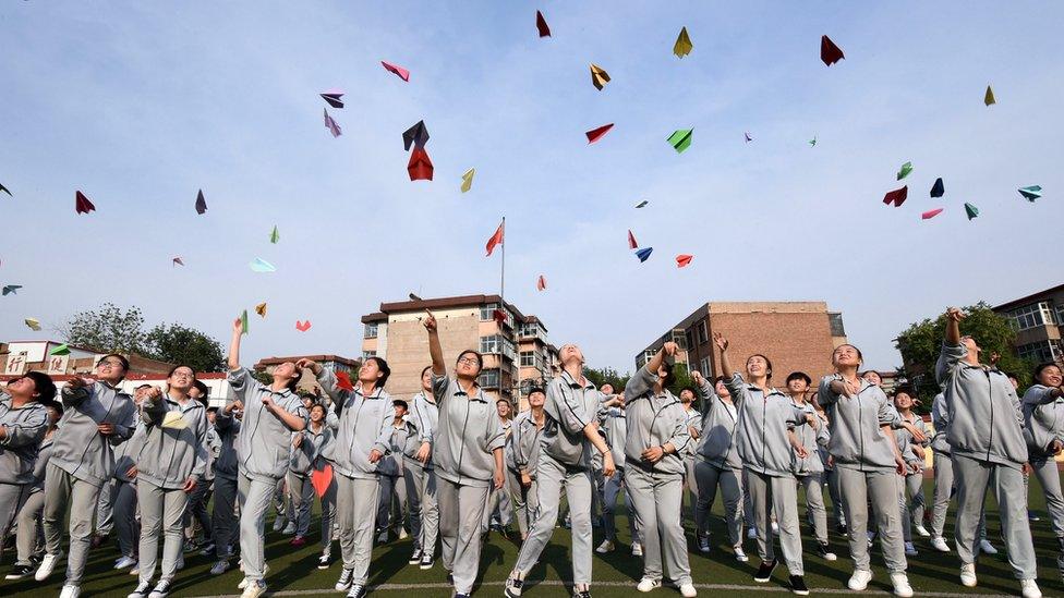 This photo taken on May 24, 2016 shows senior high students flying paper planes to release stress before the college entrance exams at a high school in Handan, north China's Hebei province