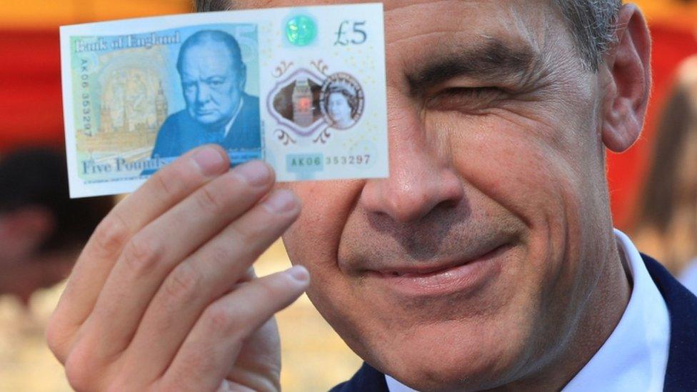 Bank of England governor with new £5 note