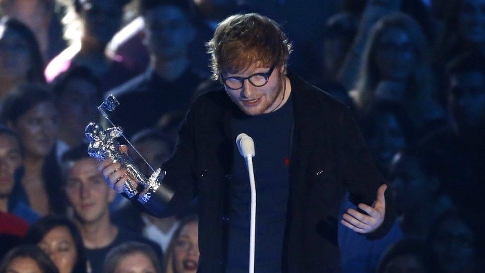 Ed Sheeran on stage with award