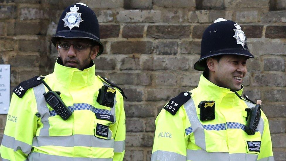 Officers with helmets on