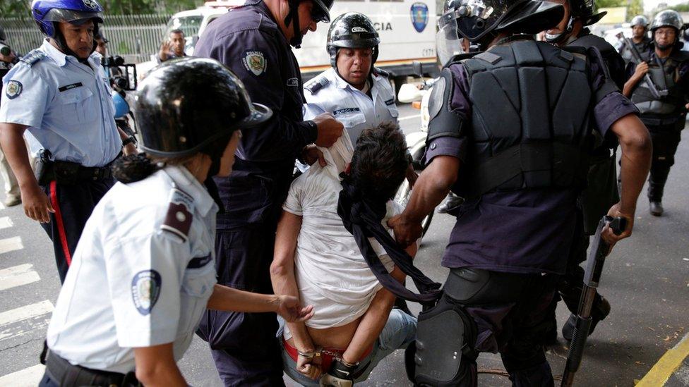 A protester is detained