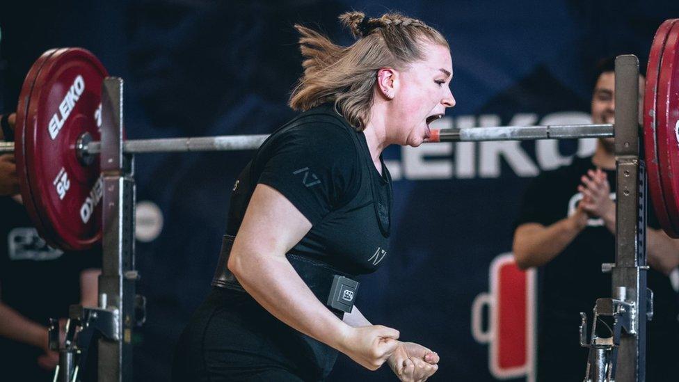 Phoebe Pothecary shouting and celebrating after powerlifting in a gym