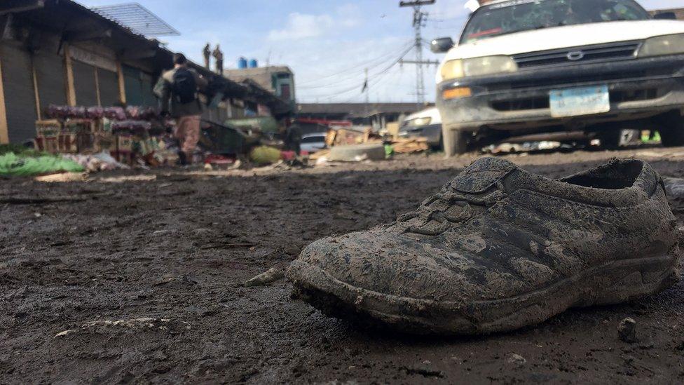 A lone shoe is seen covered in mud, among other debris, a the site of the bomb blast in Parachinar on Saturday