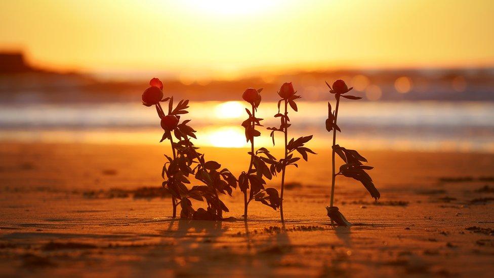 Flowers on the beach for the five who died