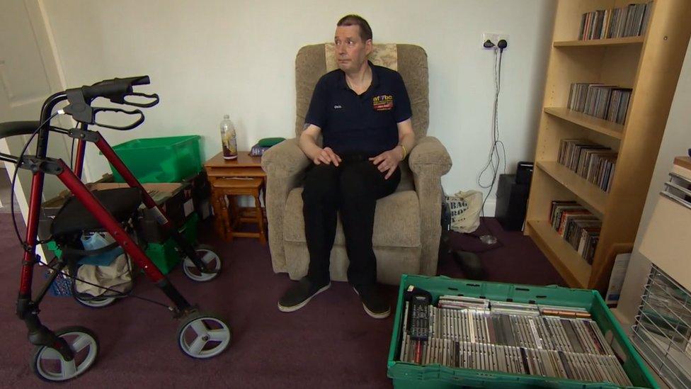 Man sitting on an armchair in a bungalow