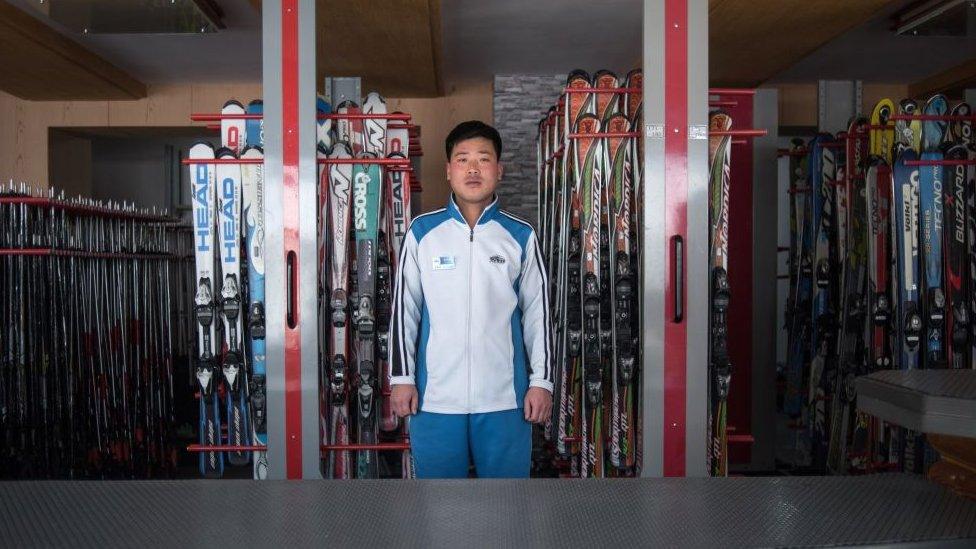 In this photo taken on February 20, 2017, Kim Chol-Nam, 30, poses for a portrait at the ski hire desk