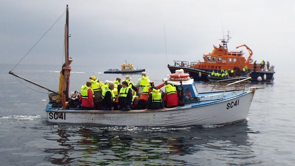 Passengers wearing lifejackets