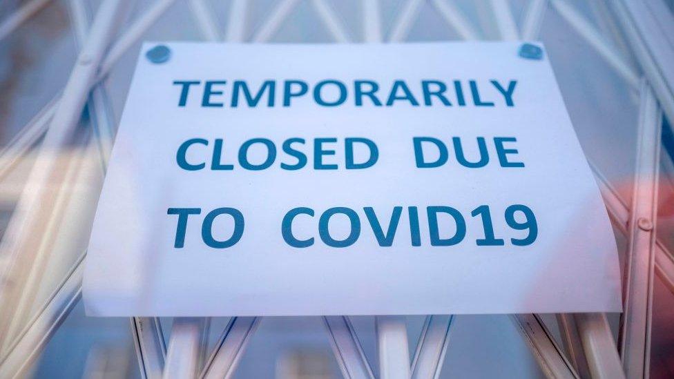 A sign that reads: Temporarily closed due to Covid-19