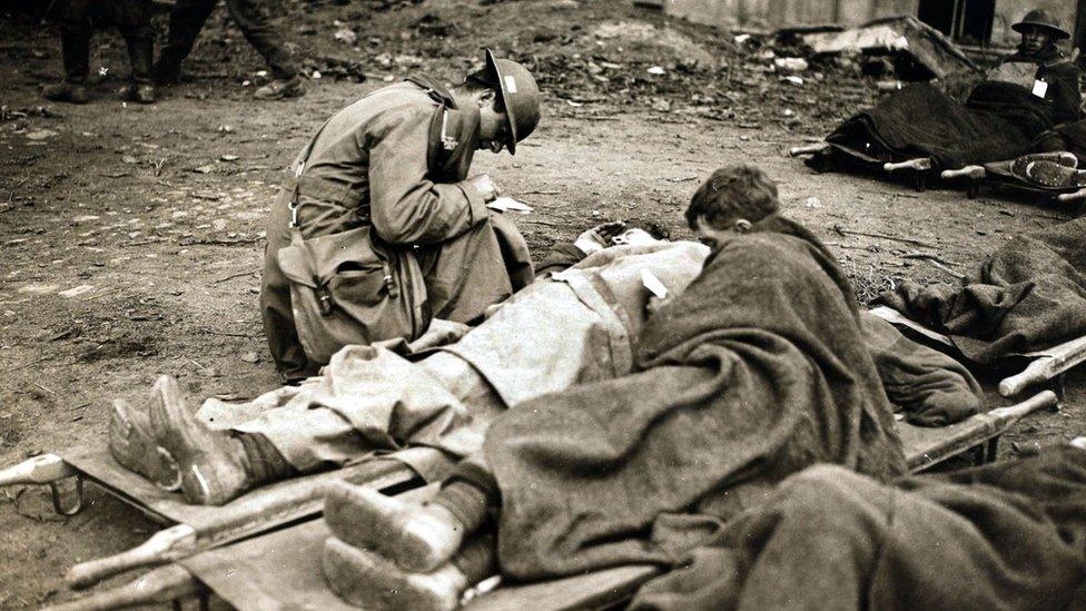 A chaplain writing letters home for wounded British troops during the British victory at Cambrai, France, 1917