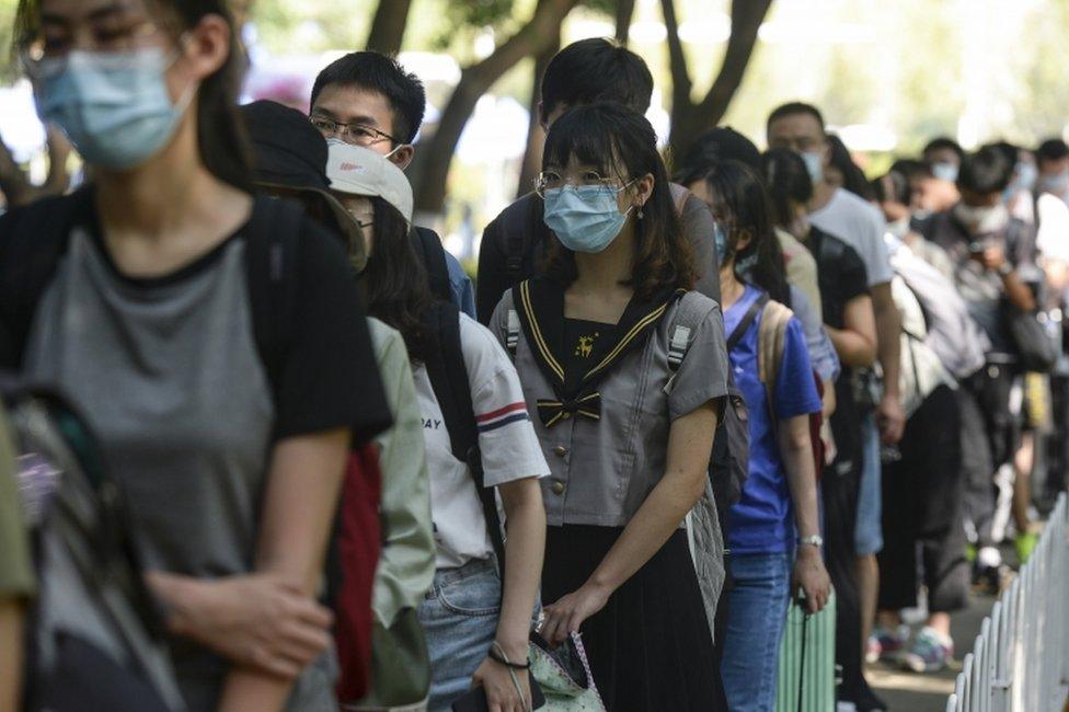 Students returning to study at university in Wuhan