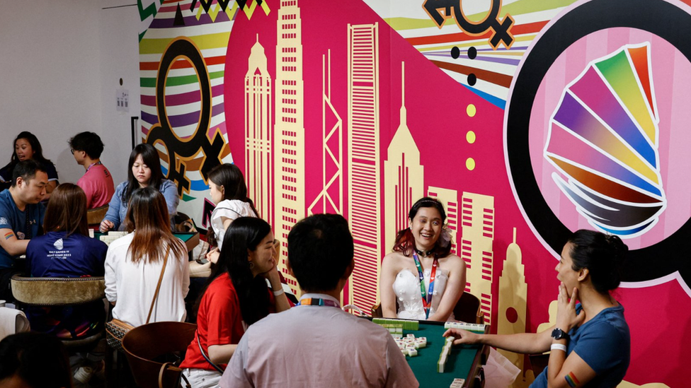 Competitors sit around mahjong tables during a Gay Games event in Hong Kong