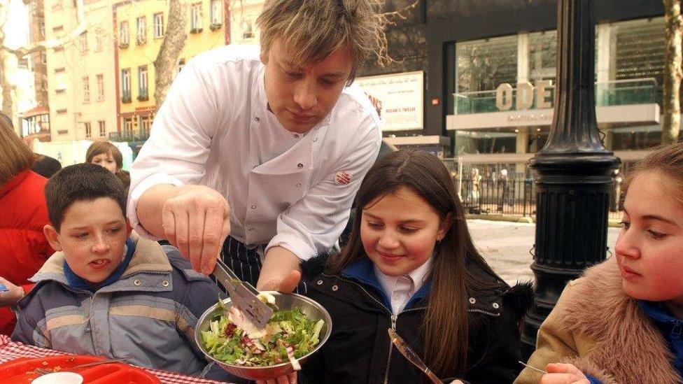 Jamie serves salad