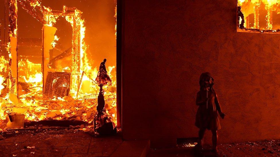 A home burns as the Camp Fire moves through the area on November 8, 2018 in Paradise, California