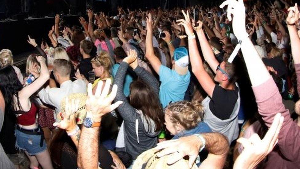 Revellers dance during a festival. File photo