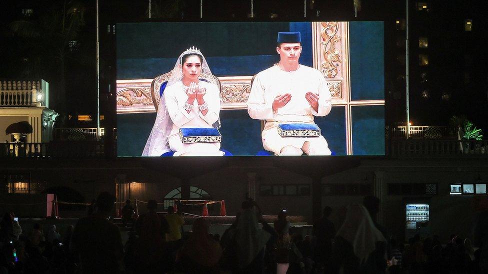 The wedding ceremony is projected on a giant screen for public viewing at Dataran Bandaraya (city square) in Johor Bahru