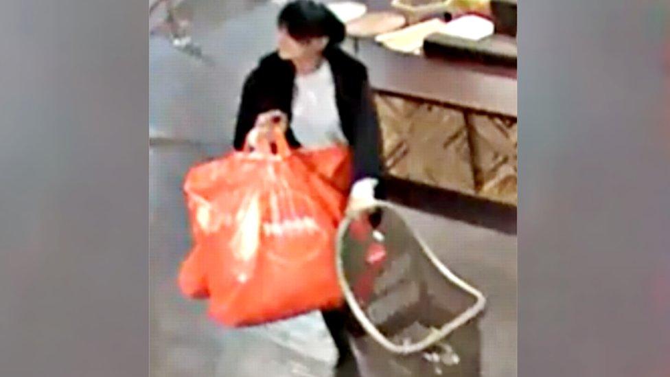 Narinder Kaur pictured on store camera with orange shopping bags