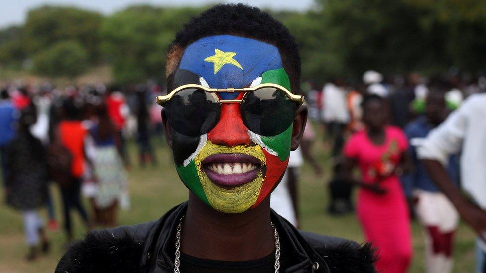 A woman with her face pointed in the colours of South Sudan's flag - Juba, July 2018