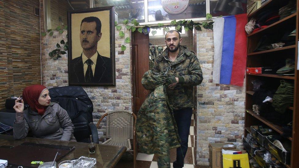 A customer at a shop selling military goods in the Syrian coastal city of Latakia, catering to Russian soldiers