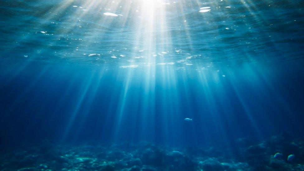 Water sea surface with light pouring in