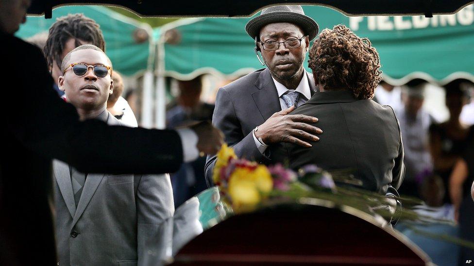 Parents of Tywanza Sanders, Tyrone Sanders and Felicia Sanders comfort each other at the graveside of their son Saturday, June 27, 2015,