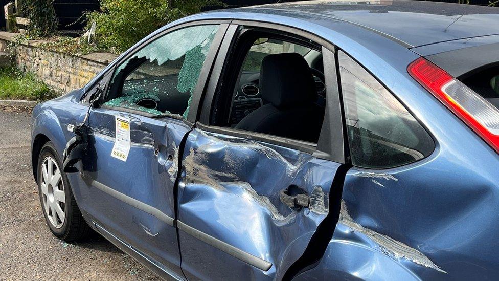 Car smashed by military truck