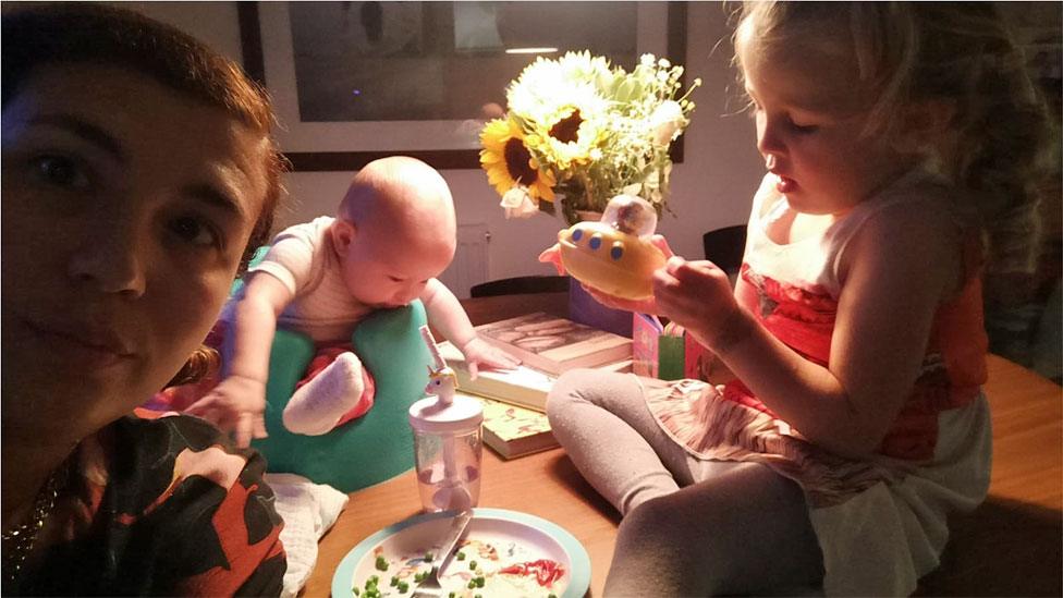 The kids sitting 'on' the table for dinner