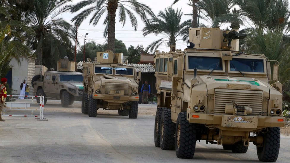 Security forces patrol near the al-Rawda mosque in the northern city of El-Arish, Sinai, Egypt (23 November 2018)