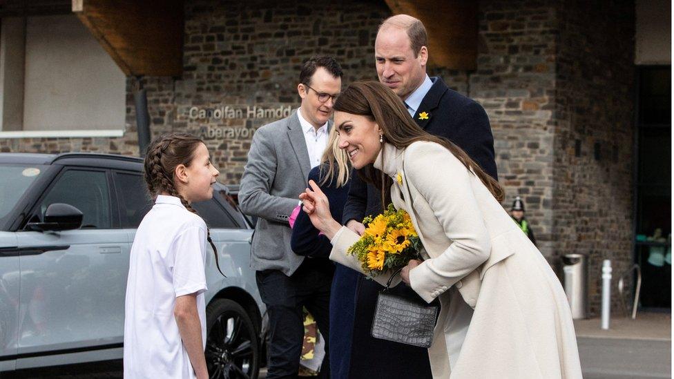 little girl talking to Kate and William