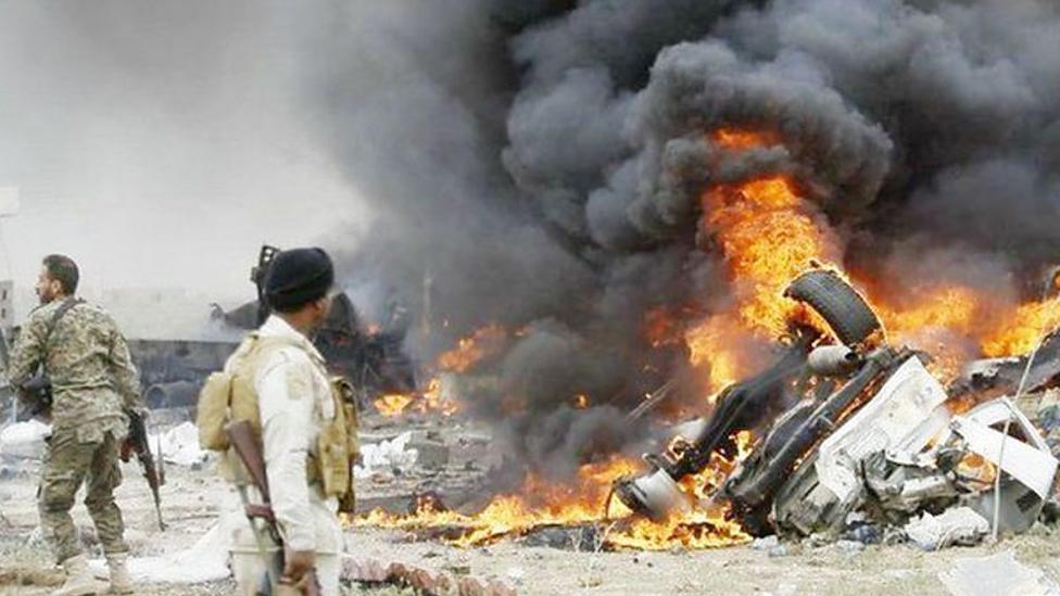 Smoke rises from a car bomb that exploded in a suicide attack on Iraqi government forces by a suspected IS militant on the southern edge of Tikrit, Iraq in March 2015