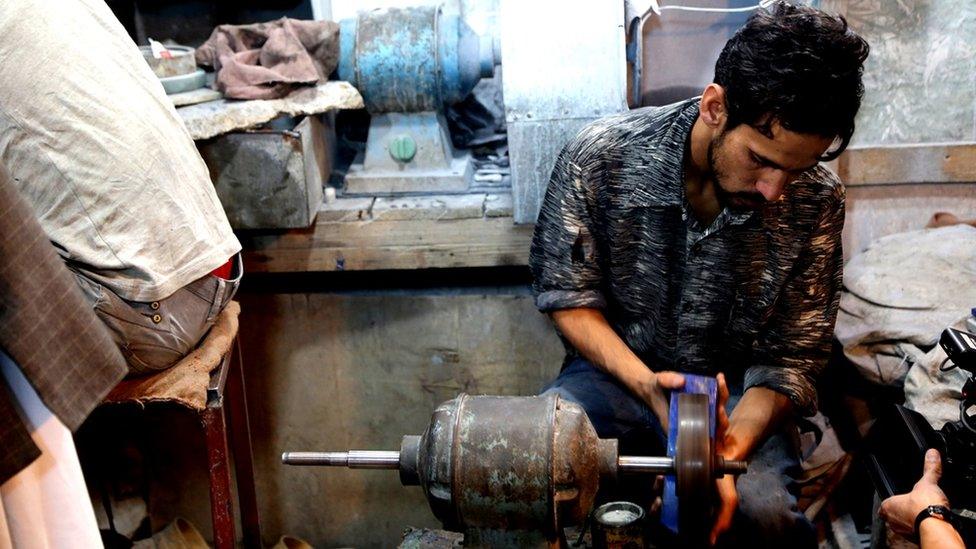 A craftsman polishing lapis lazuli, a semi precious stone mined in Afghanistan's northern Badakhshan province.