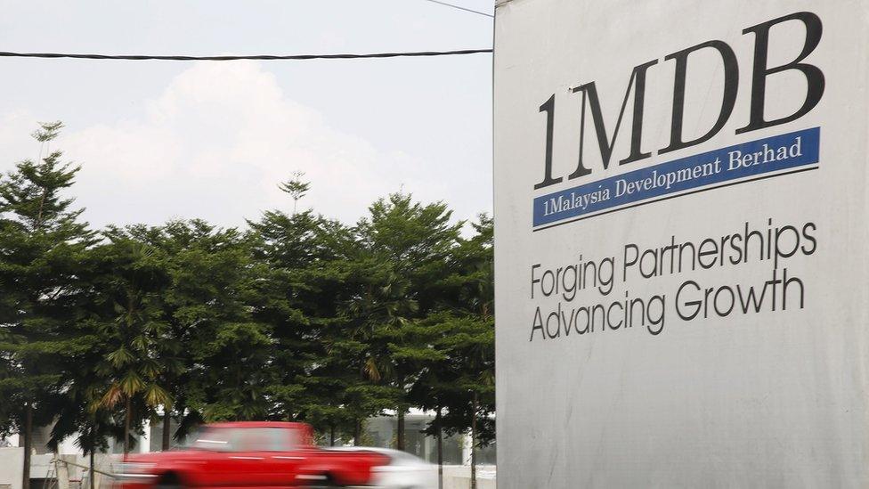 Traffic passes a 1Malaysia Development Berhad (1MDB) billboard at the Tun Razak Exchange development in Kuala Lumpur, Malaysia, in this file picture taken July 6, 2015