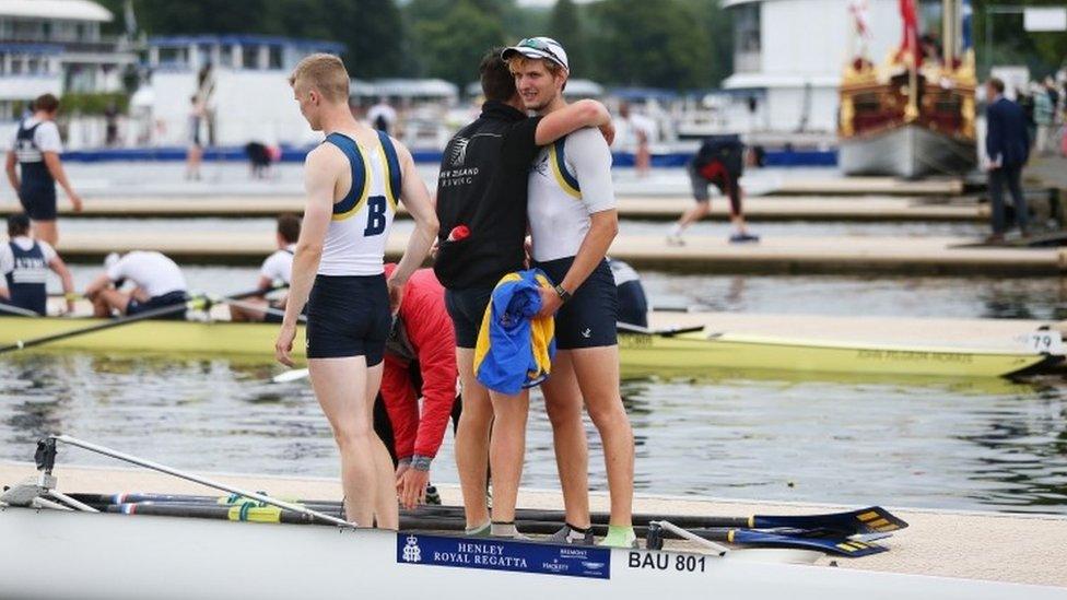 Crew from the University of Bath congratulate each other after winning their race.