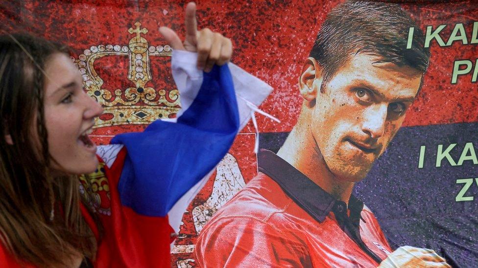 A supporter of Serbian tennis player Novak Djokovic rallies outside the Park Hotel, where the star athlete is believed to be held while in Melbourne, Australia, 7 January 2022