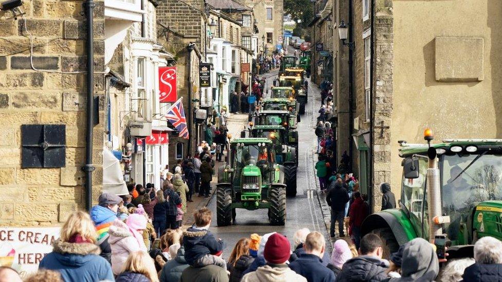 A convoy of tractors travel through Pateley Bridge