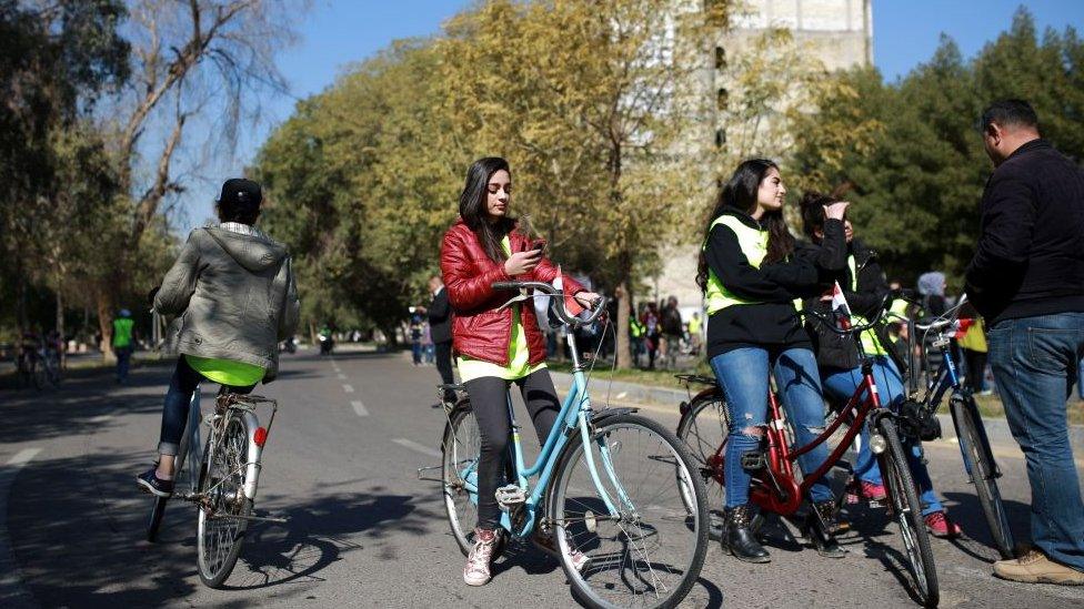 cyclist on phone in Iraq