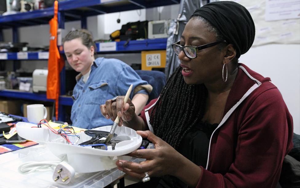 Volunteers repair electrical items at the Fixing Factory in Camden, London