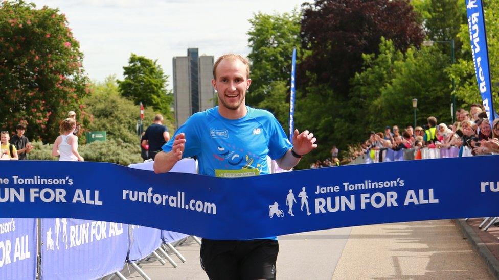 Philip Nind crossing the finish line at Nottingham's 10K road race