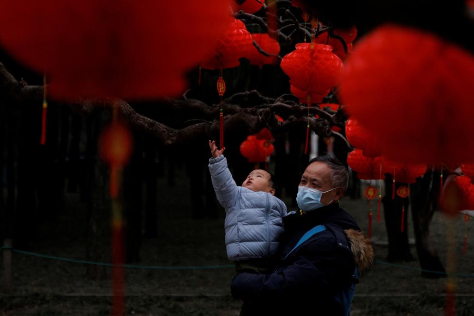 A child reaches for Spring Festival ornaments in a park ahead of Chinese Lunar New Year festivities in Beijing, China, 11 January 2023.